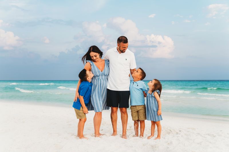 family of 5 photoshoot in Destin looking at each other