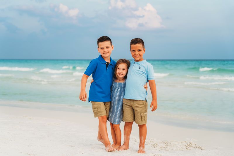 3 kids hugging each other and laughing