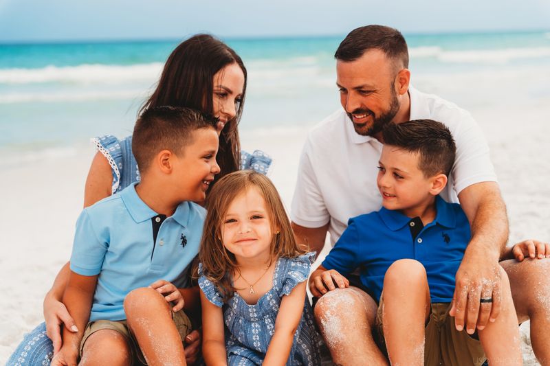 closeup shot of a family sitting on a sand at the beach in Destin