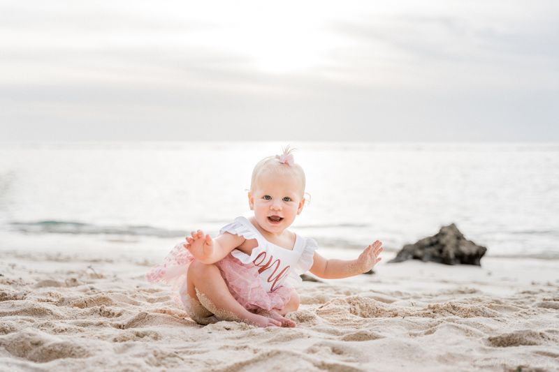little baby girl om a beach sunset photoshoot