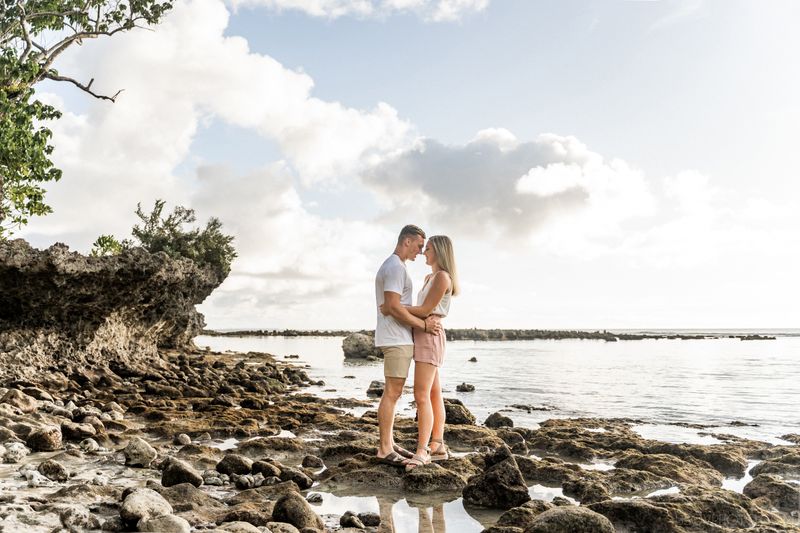 couple standing face to face surrounded by ocean, dreamy light